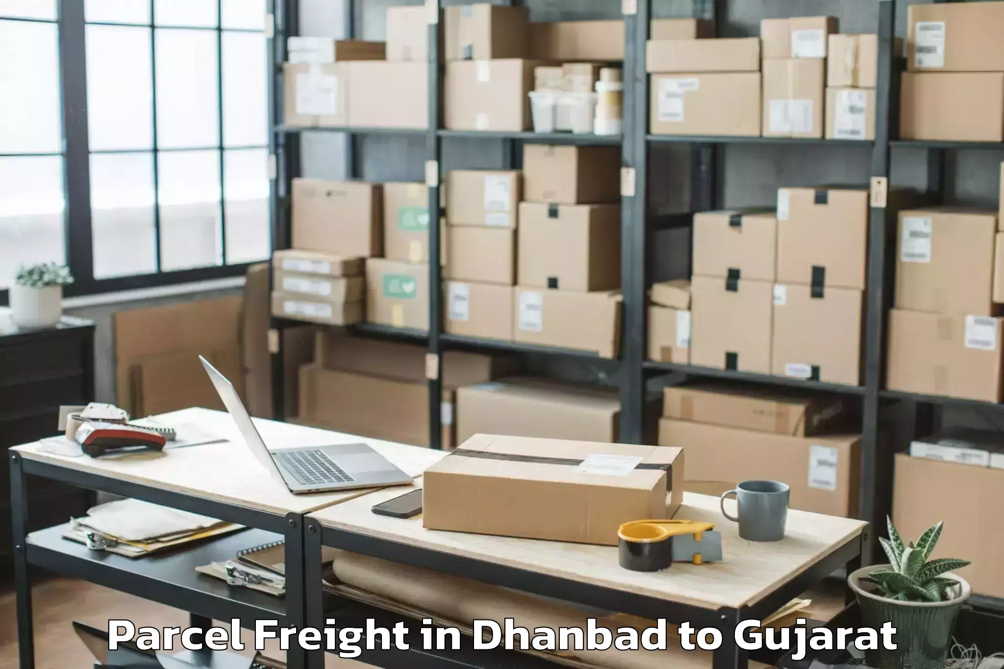 Leading Dhanbad to Tilakvada Parcel Freight Provider